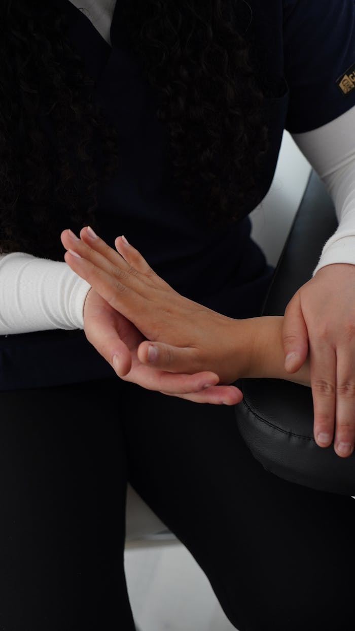 about-03 A professional therapist performing hand massage to relieve tension and improve wellness.